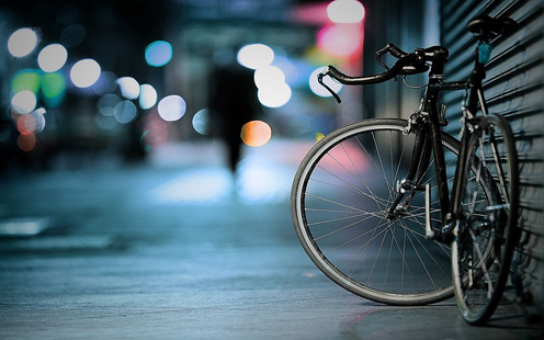 Bike leaning on wall at night