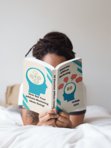 Girl reading 80 Essential Affiliate Marketing Terms while lying on bed